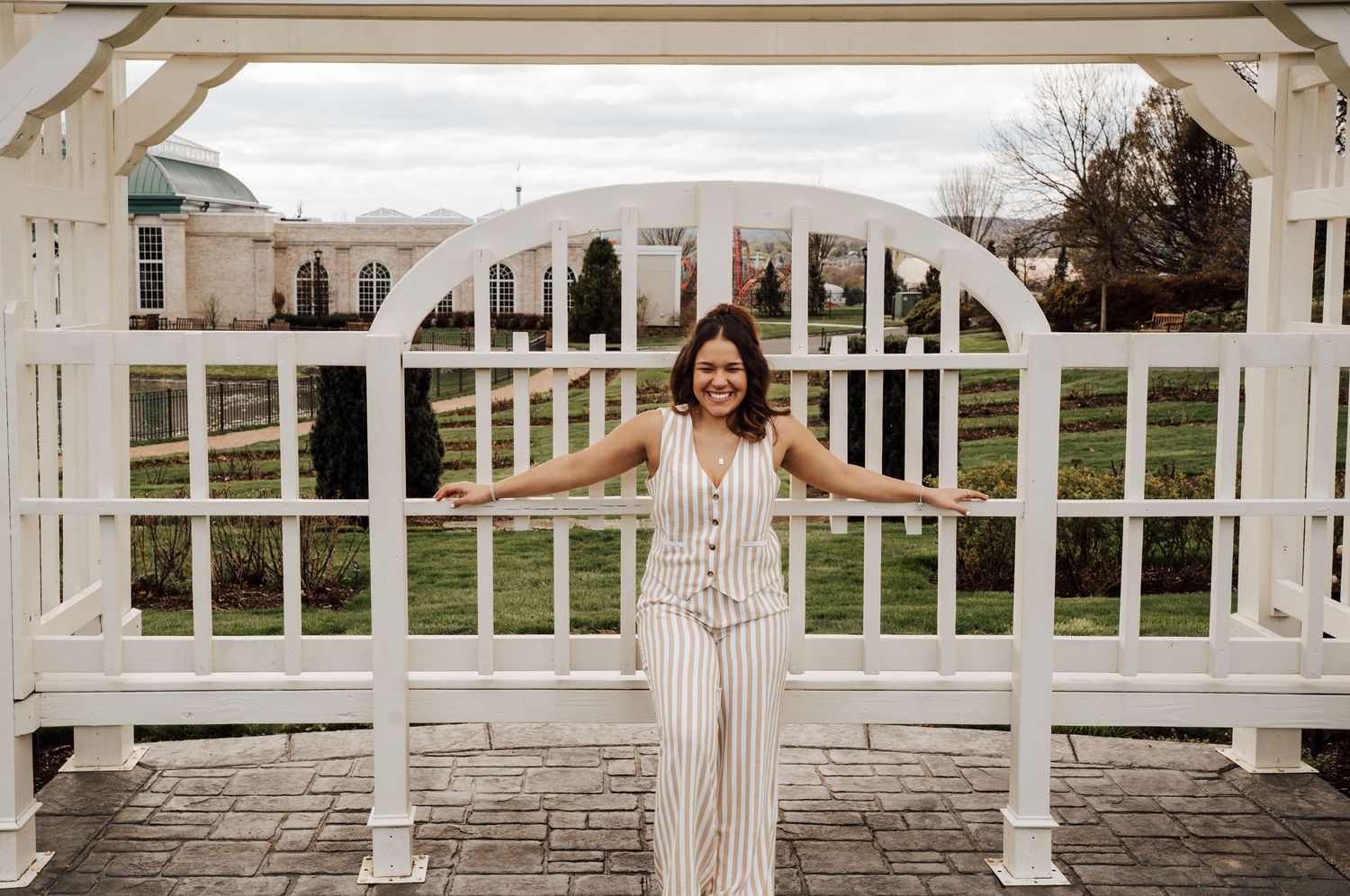 High school senior posing for senior portraits at Hershey Gardens.