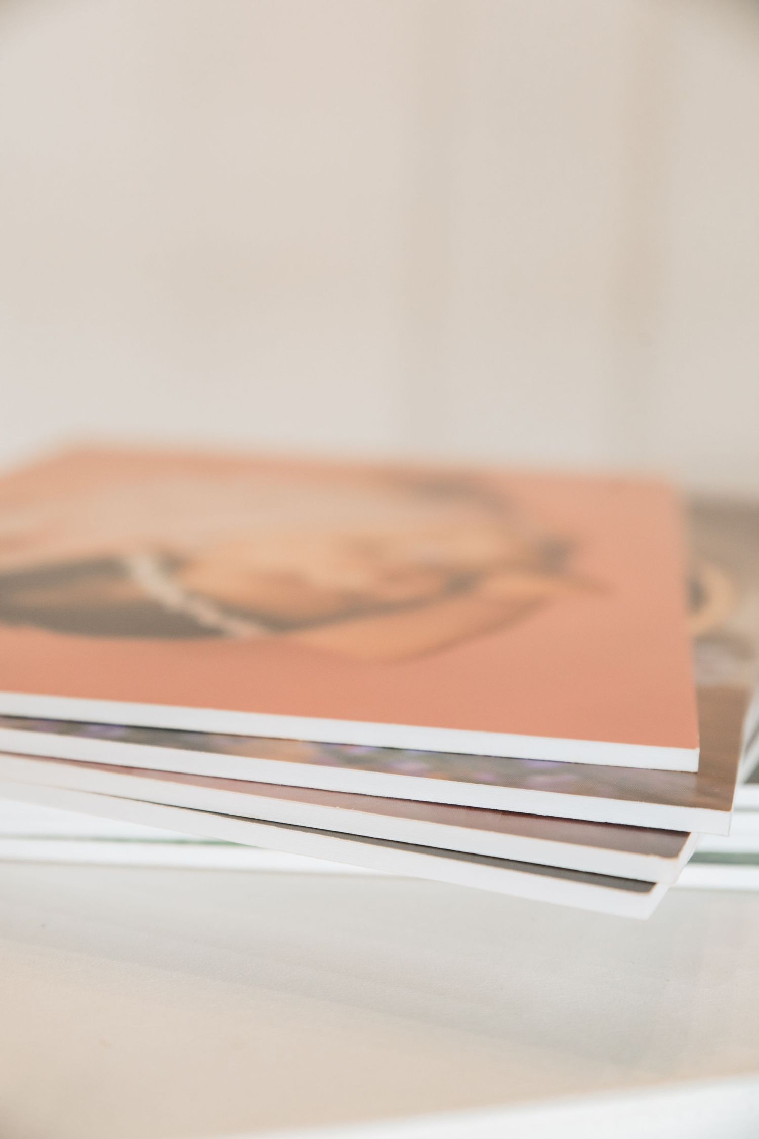 Close-up view of professional photo prints stacked with clean white edges.