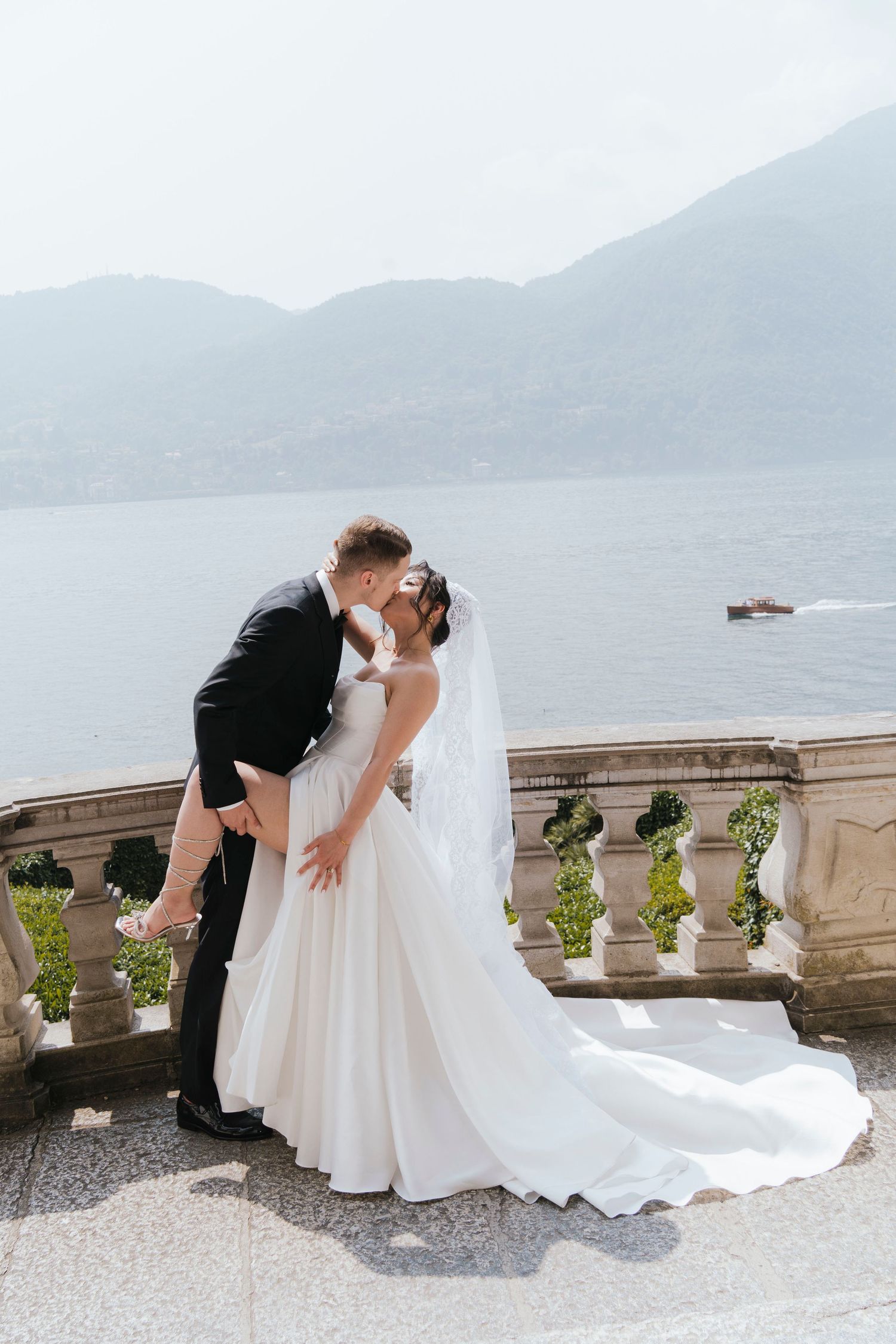 The series shows the progression of a romantic wedding portrait sequence overlooking the ocean from an elegant balcony terrace.