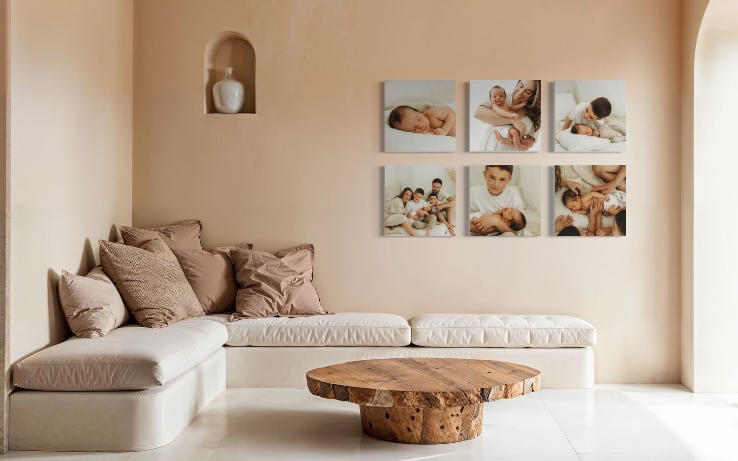 A modern minimalist living room with beige walls, wood furnishings and framed photographs displayed as wall decor.
