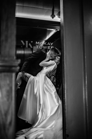 Four black and white photographs show a person in a flowing white dress leaning around a dark corner or doorway.
