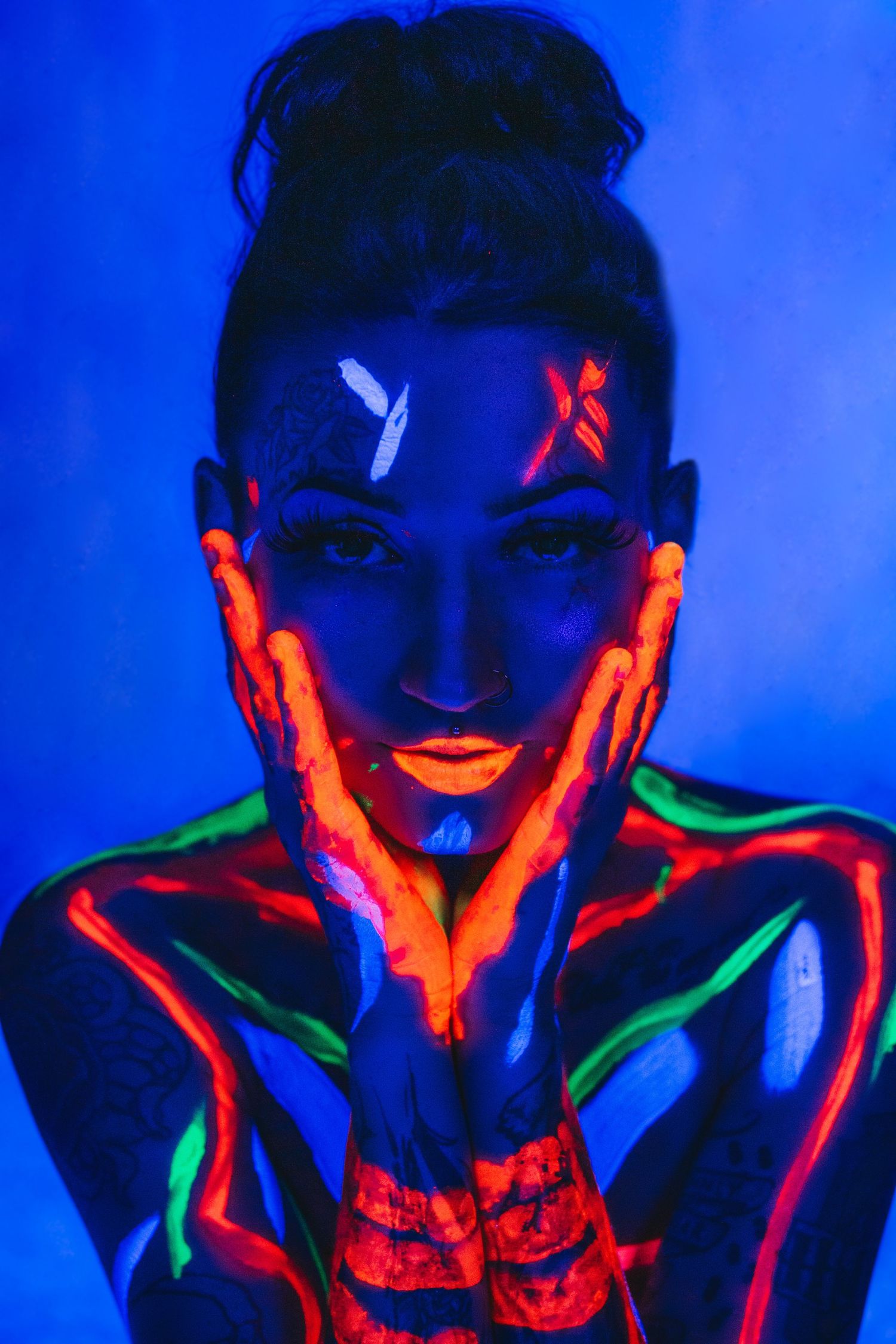 Bold boudoir photo using neon paint and UV lighting.