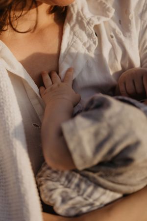 Soft focus image of textured white fabric and clothing details.