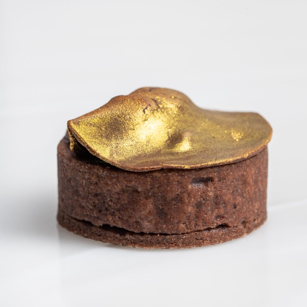 Assorted personal-sized desserts styled for Lumière Patisserie, captured in a professional food photography setup.