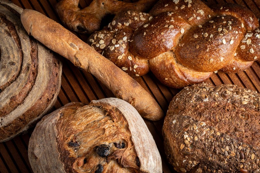 Overhead shot of Artisan sourdough bread on a wooden background.