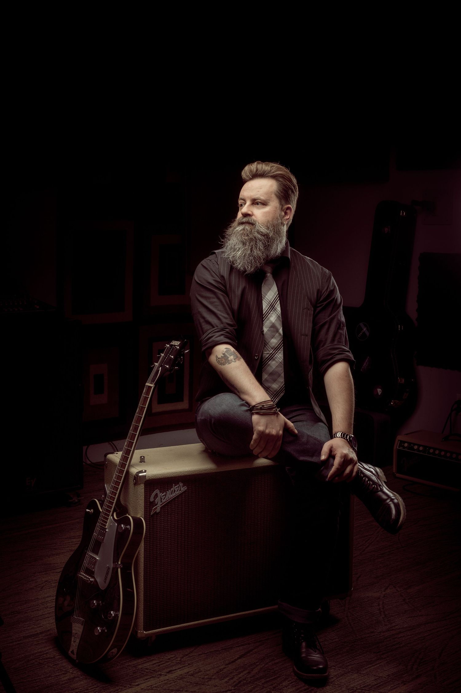 Musician captured in low-key studio lighting for a dark, atmospheric look.