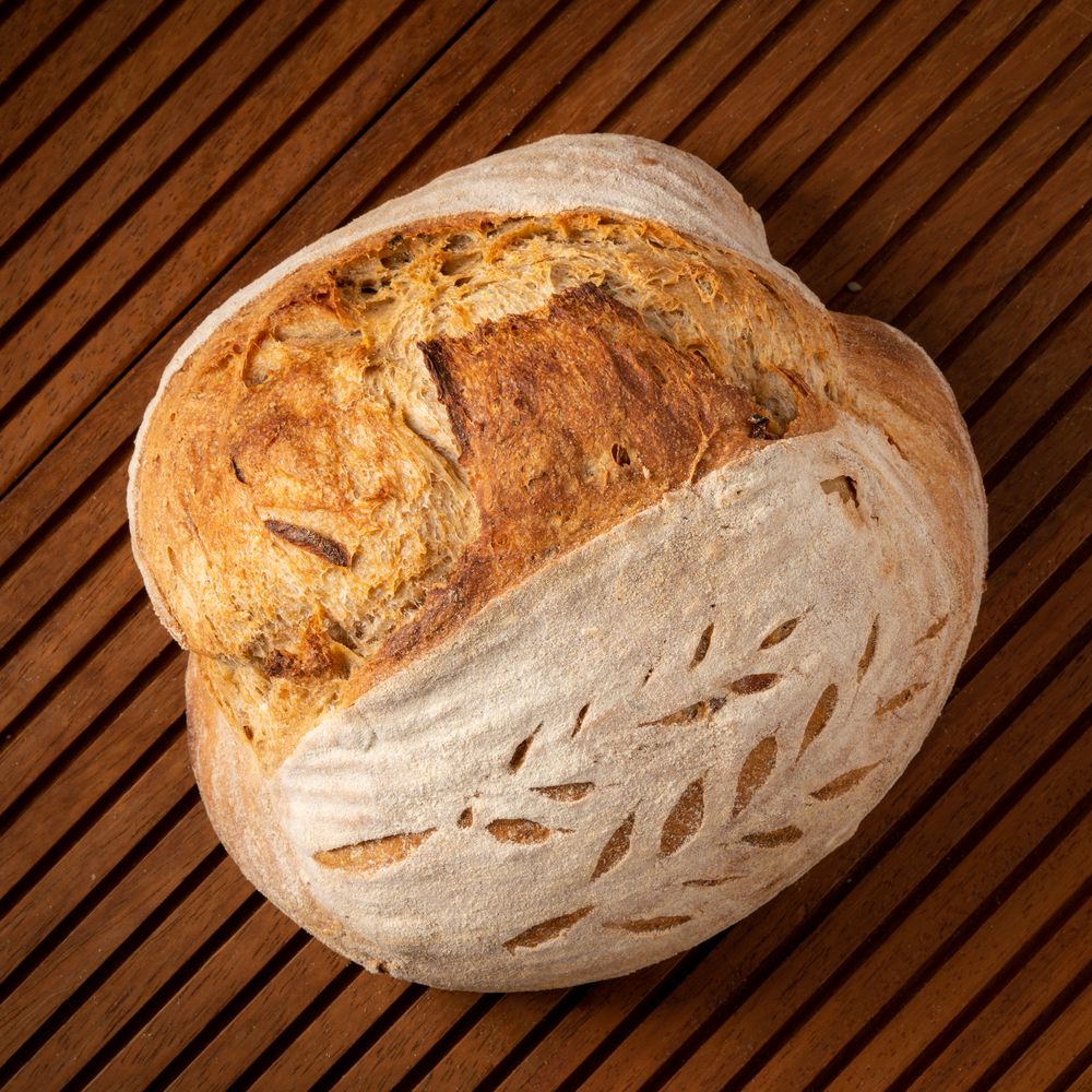 Photo of a loaf of sourdough bread with a crispy crust.