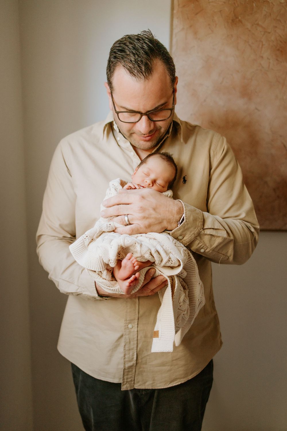 Father holding newborn in home photography session in Port Noarlunga