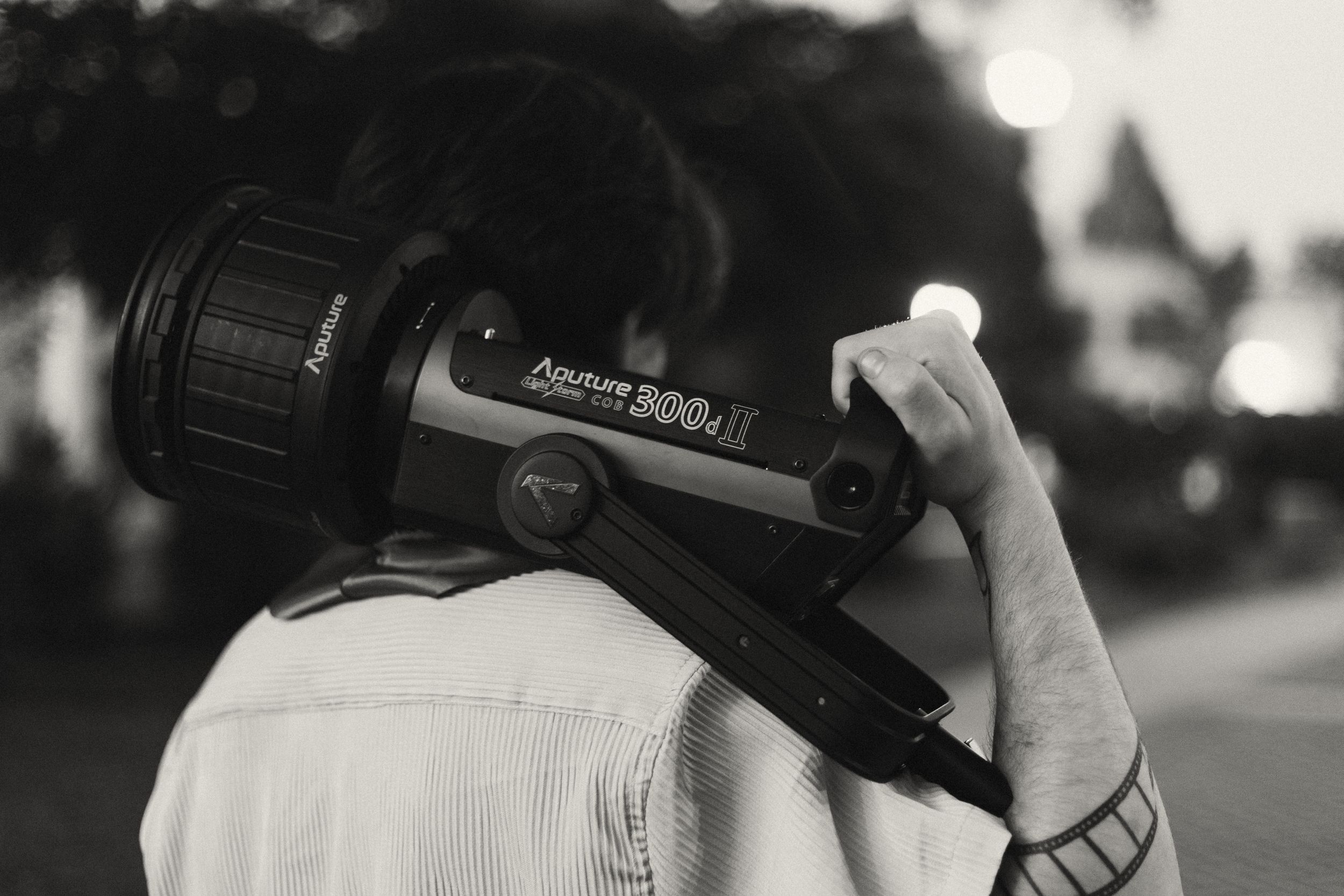 Black and white photo sequence shows camera equipment being held and manipulated in different positions.