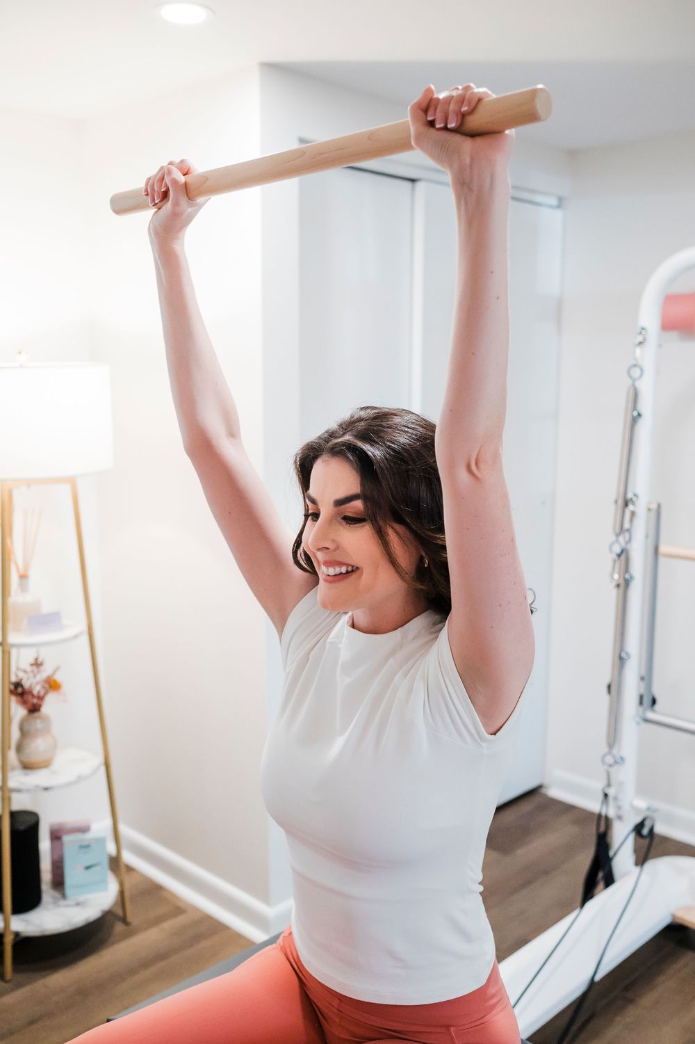 Person stretching with exercise equipment in a bright home workout space.