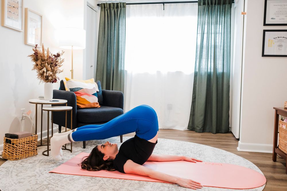 Series of shots showing stretching and workout positions on a pink exercise mat in a light-filled room.
