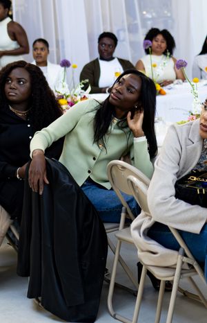 Event attendees relaxing in chairs during a social gathering.