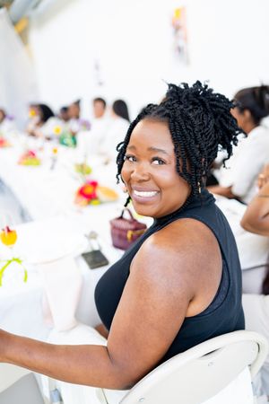 Guests enjoying themselves at a social gathering in a bright indoor setting.