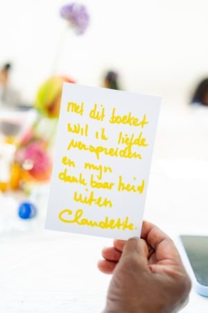 Handwritten yellow notes displayed against a white background at an event.