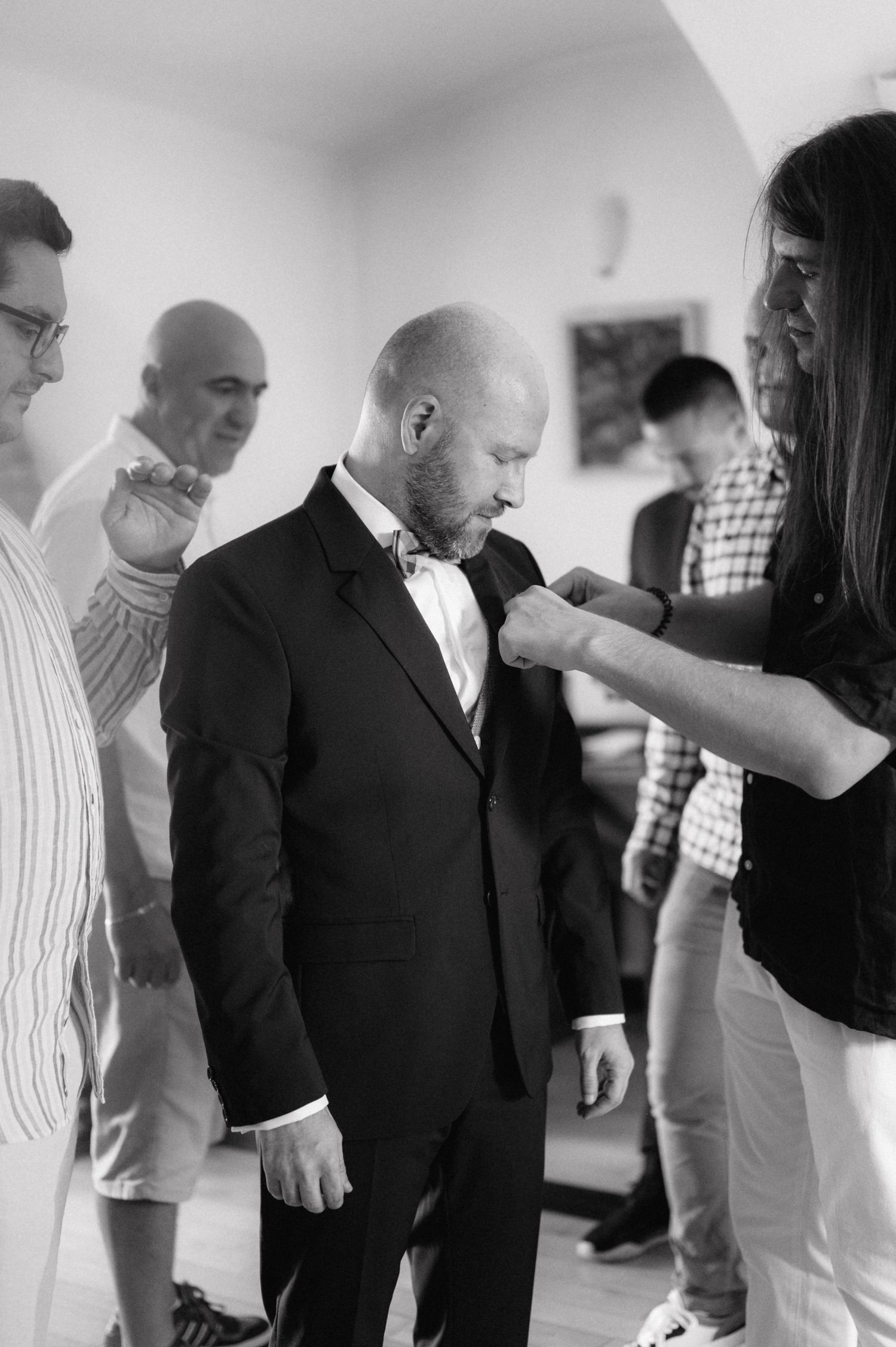 Multiple black and white images showing people dancing and moving in sequence in a relaxed indoor setting.