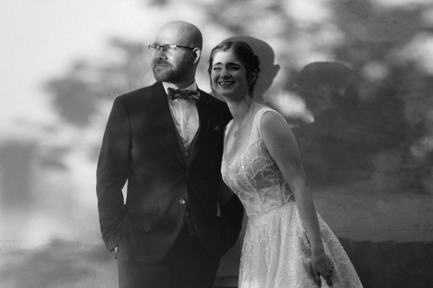 Vintage black and white wedding portrait of a couple in formal attire with soft focus and dreamy atmosphere.