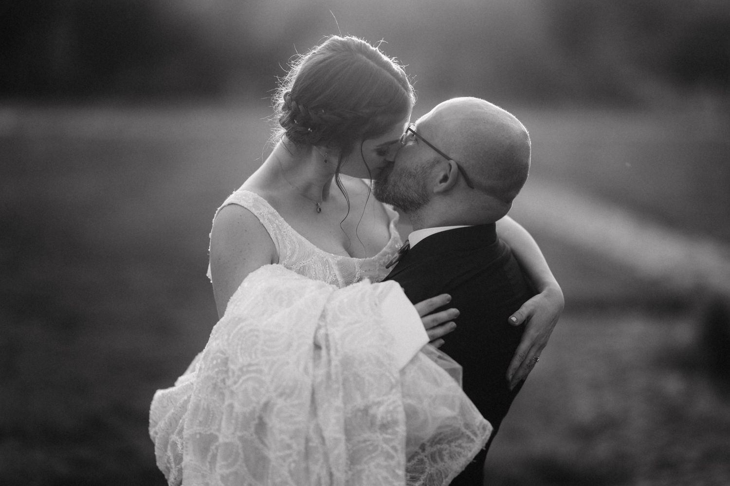 Black and white collage of romantic wedding portraits showing intimate moments at an outdoor celebration.