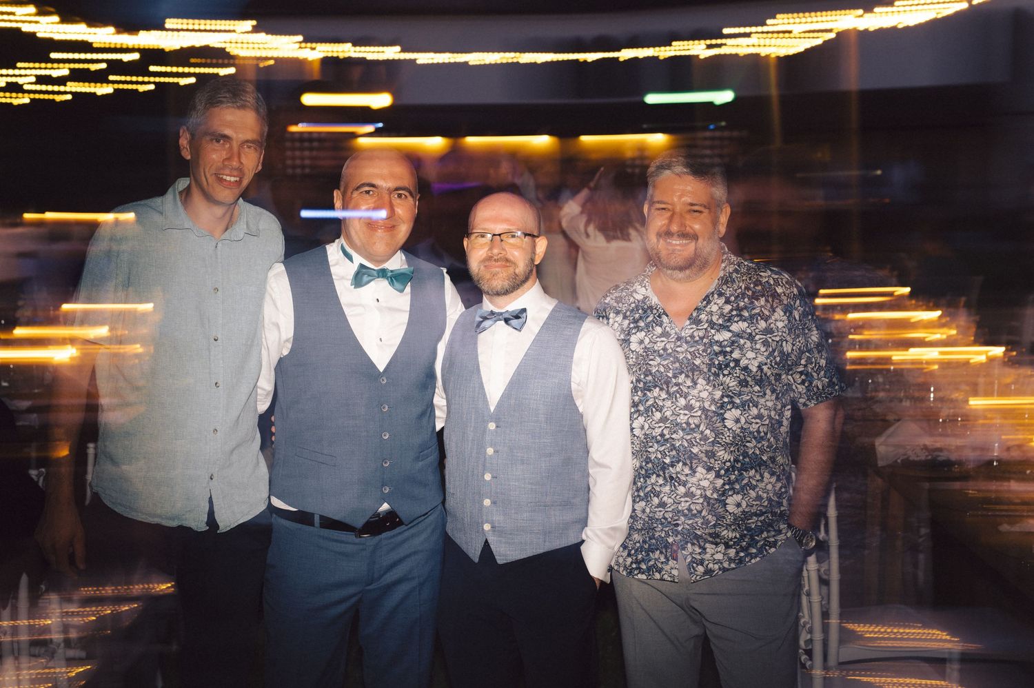 A series of dimly lit party or event photos showing people gathered in formal attire with a dark interior background.