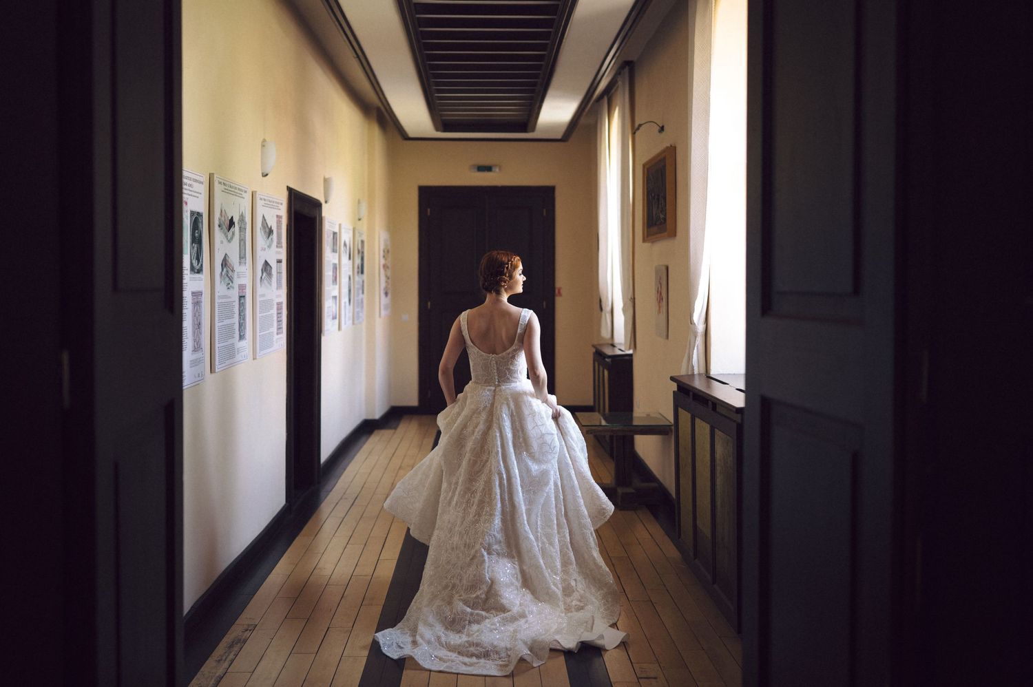 A white wedding dress worn by a figure walking down a dark hallway in a series of candid photos.
