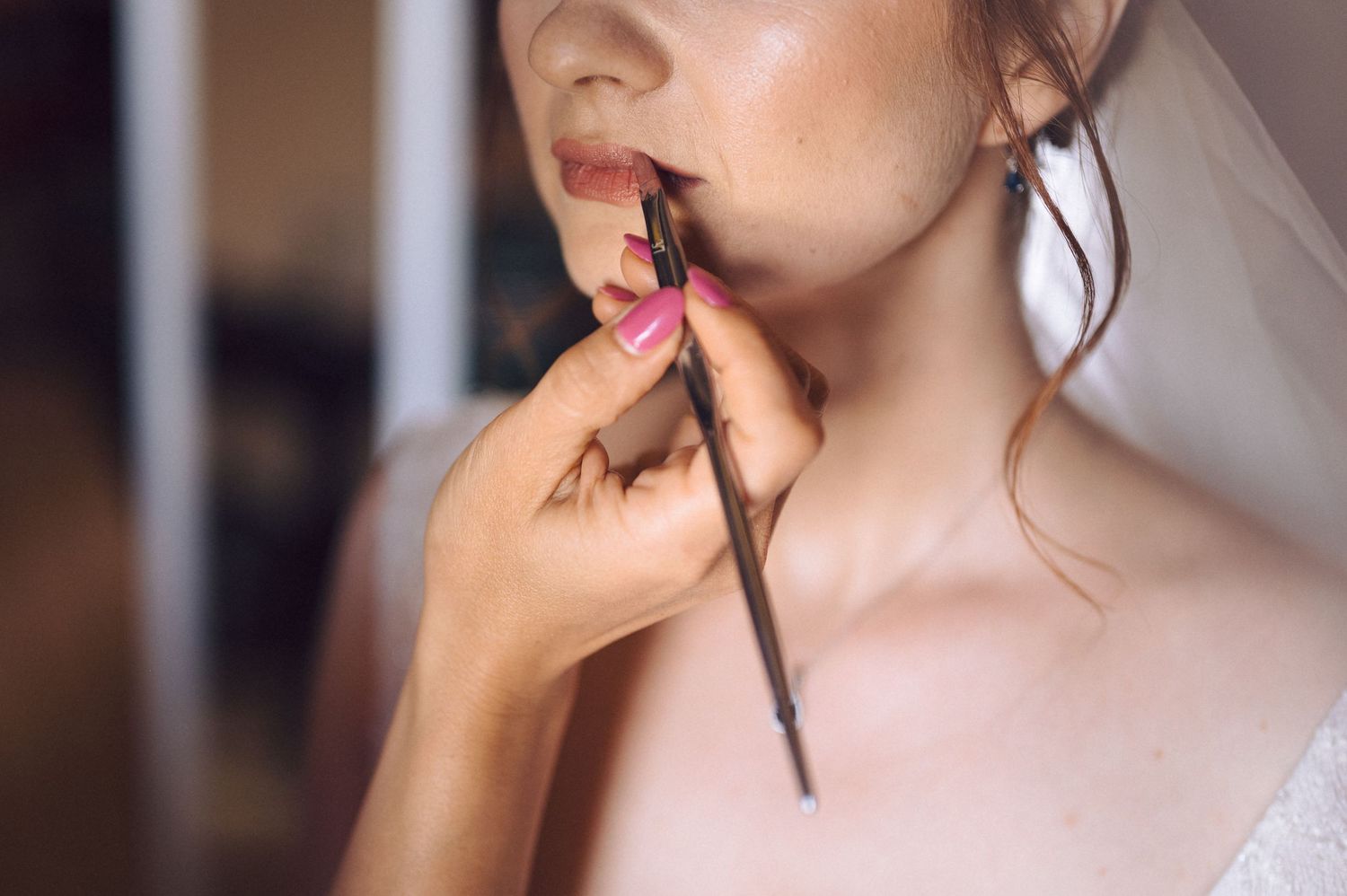 Close up footage shows cosmetic lipstick application in a step by step tutorial sequence.