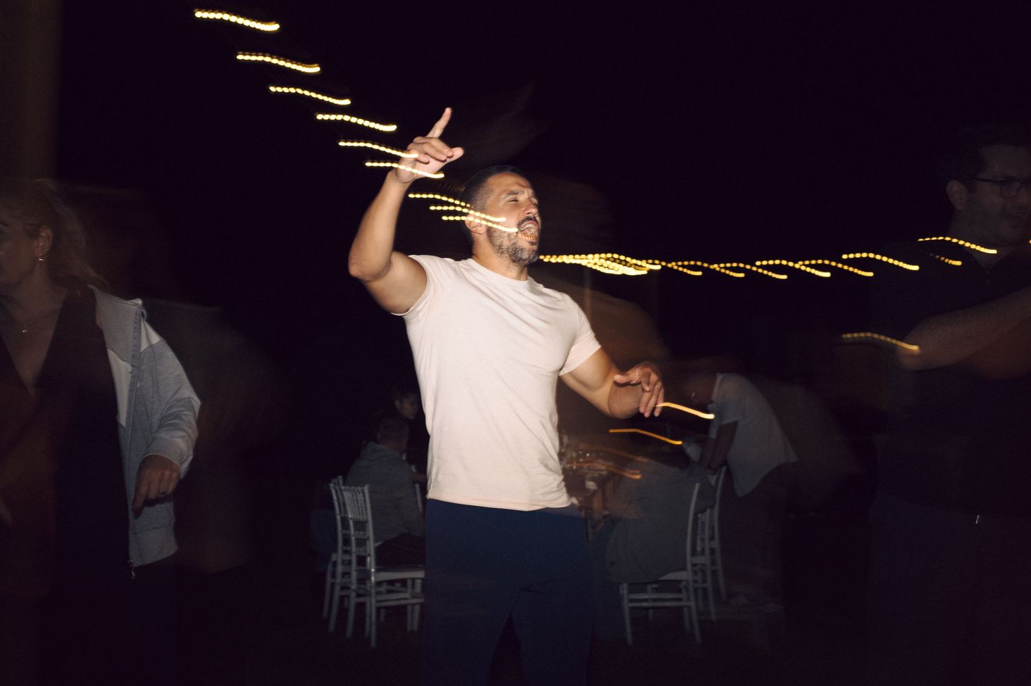 A performer tosses multiple drumsticks on stage during a drum solo performance.