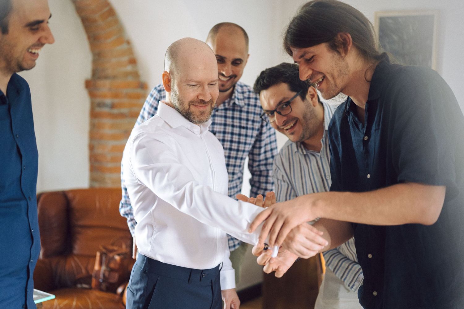 Group practices handshaking gestures in a professional business training workshop setting.