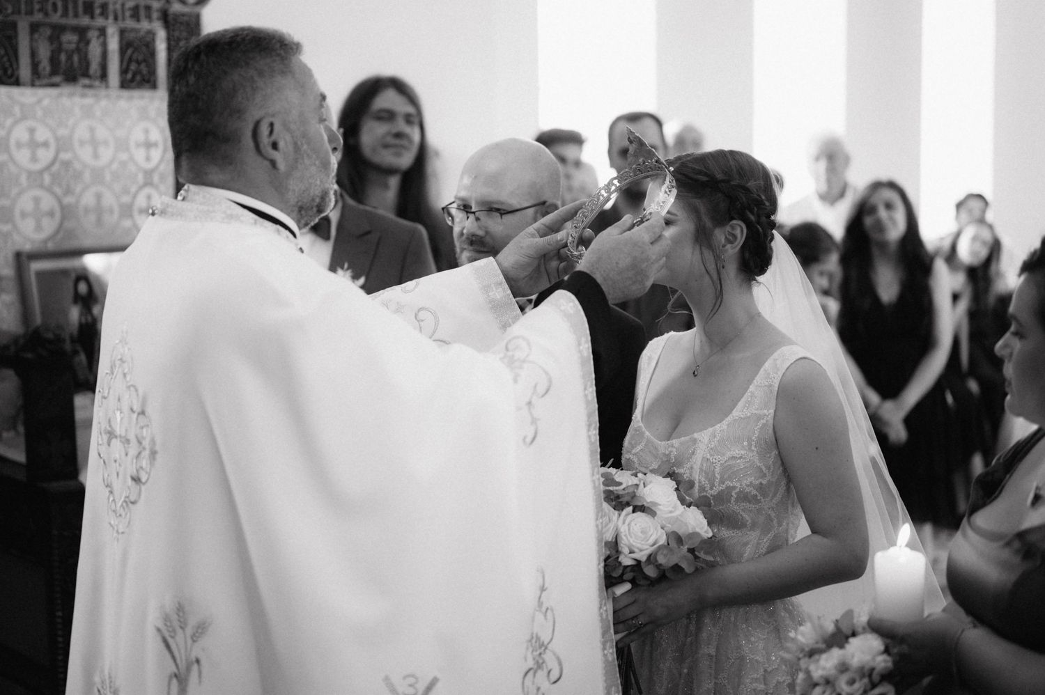 A series of black and white wedding photos showing intimate moments and celebrations between a couple and their guests.