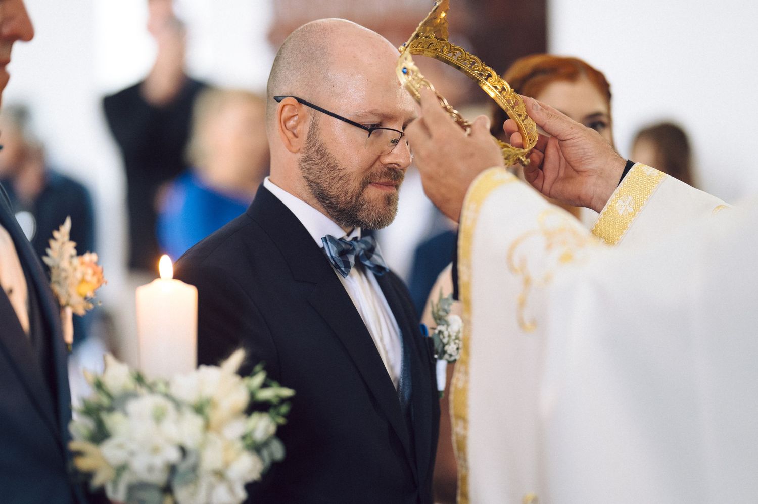 A wedding ceremony with a candle on display and live orchestra performing for the couple during their special moment.