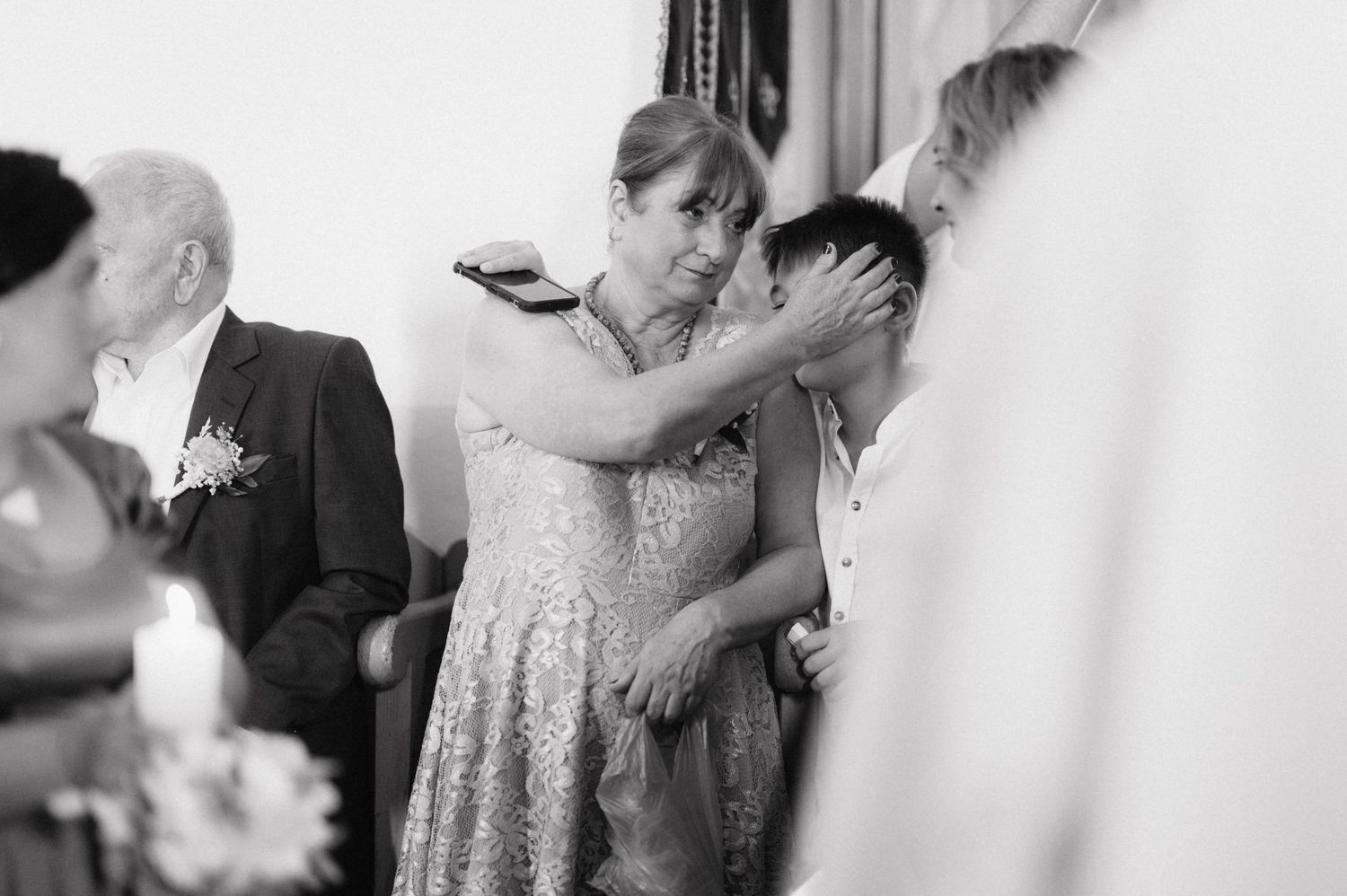 A tender emotional moment during a wedding ceremony as people embrace and share tears of joy.