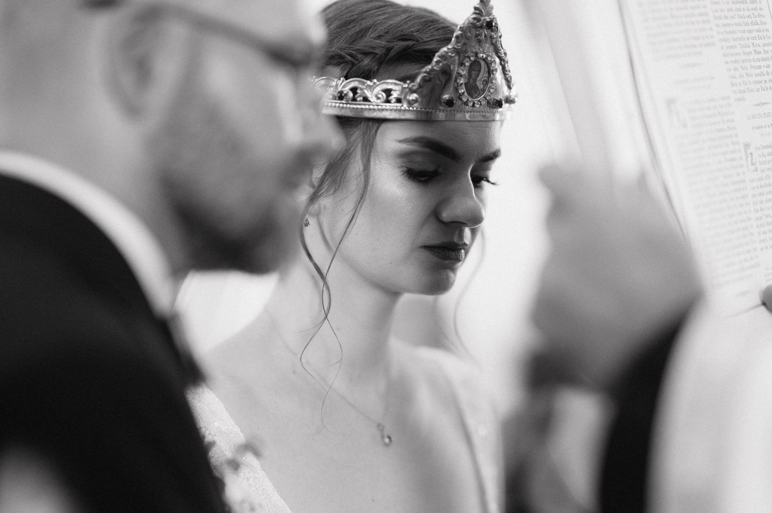 A black and white close-up of wedding preparations showing details of elegant bridal accessories and styling.