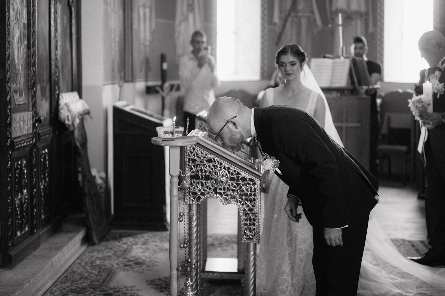 Multiple black and white vintage photographs showing glimpses of indoor scenes with furniture and people in classical settings.
