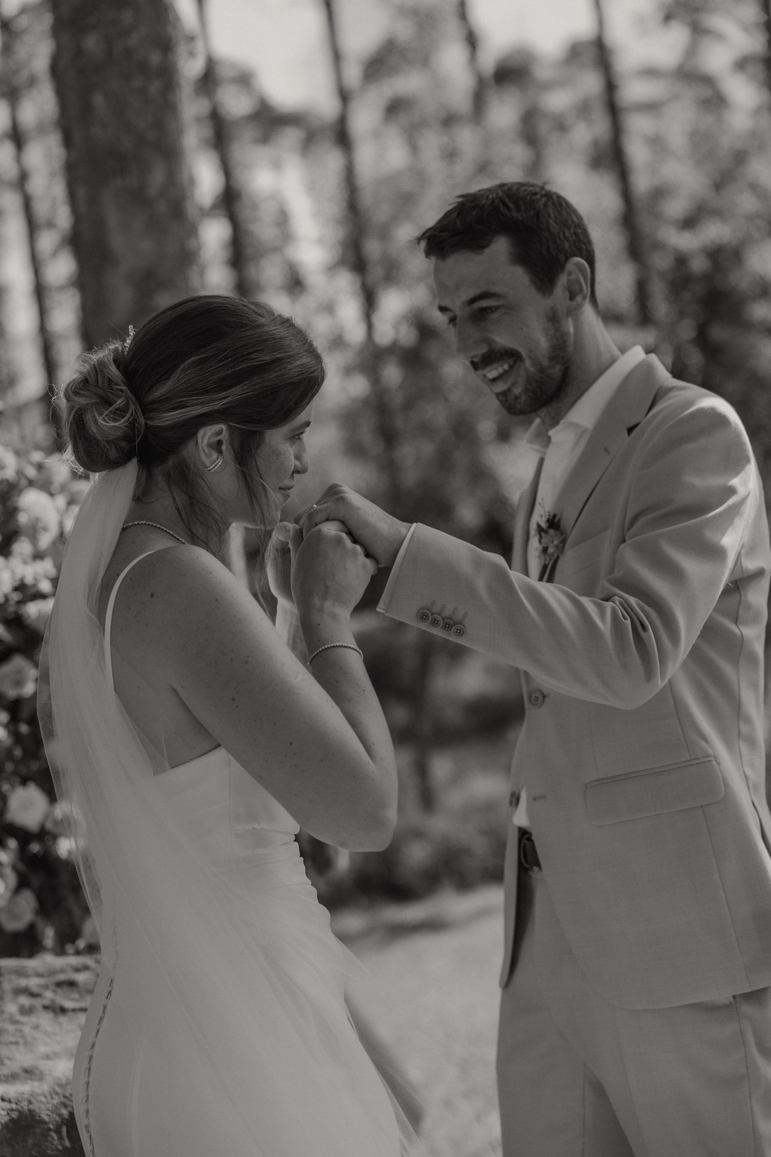 A black and white wedding moment showing couple sharing emotional exchange.