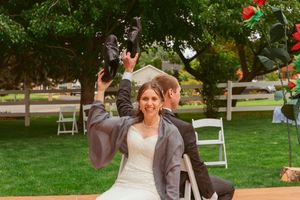 A celebratory dance moment on an outdoor wooden platform during a garden wedding.
