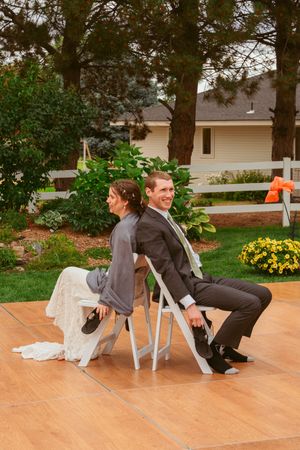 A humorous sequence showing a person falling off a chair during what appears to be an outdoor event.
