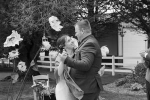 Black and white photo of couples dancing at an outdoor wedding celebration.