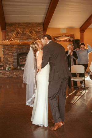 Wedding ceremony progression captured in romantic lighting with exposed brick wall and wooden beam details.
