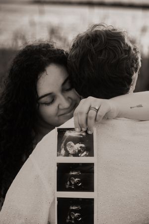 Black and white photos show hands holding ultrasound images against a light background.