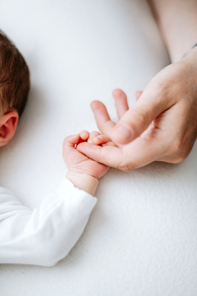 Hands grasp and pull at a white fabric sleeve close up, shown as a sequence across multiple frames.
