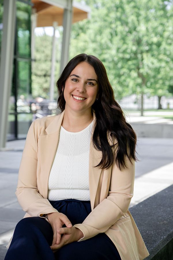 Modern headshot of woman sitting casually in a bright, outdoor location during branding session
