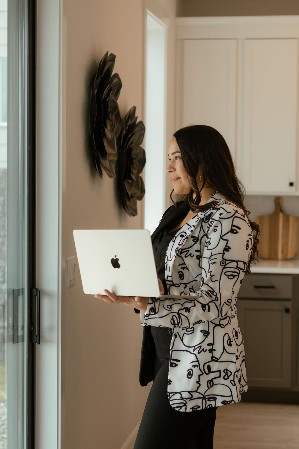 Branding photo of female realtor working at kitchen island during lifestyle business session