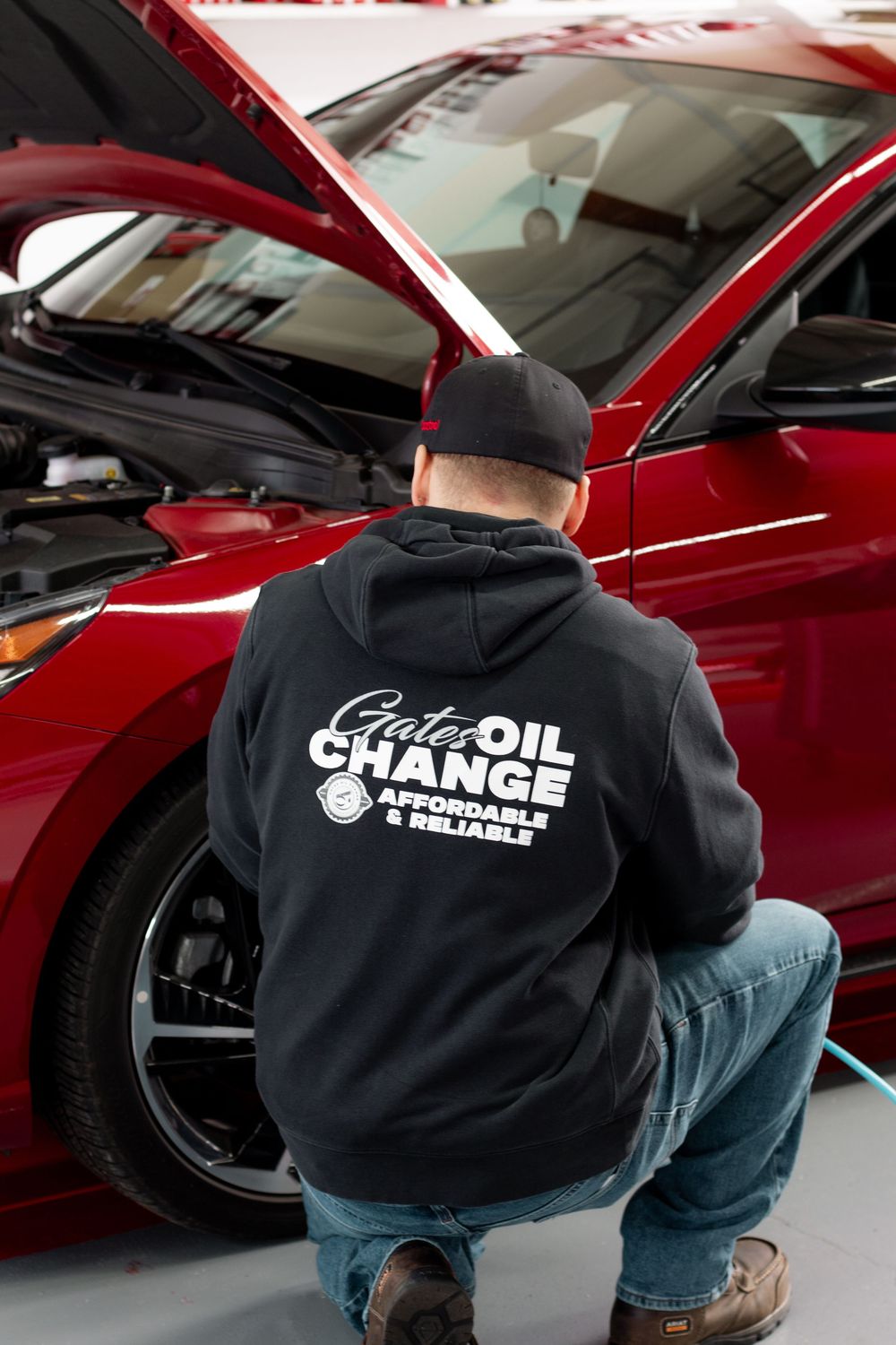 Auto technician from Quick Oil Change working on a vehicle during branding shoot in Tri-Cities WA