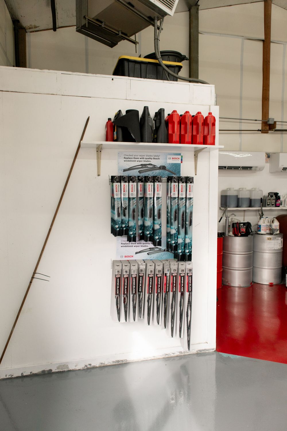 Automotive supply display inside oil change shop showcasing tools and fluids