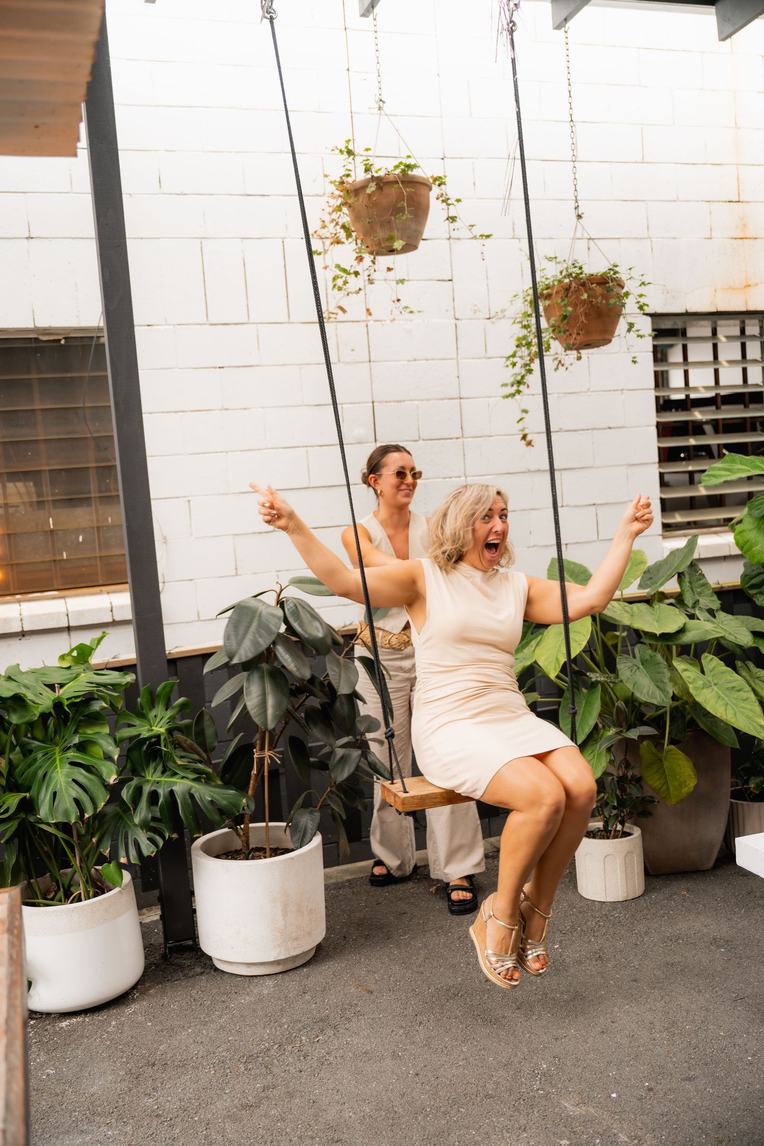 Playful branding photo of woman on a swing at a creative agency shoot - candid lifestyle business photography on the Gold Coast.