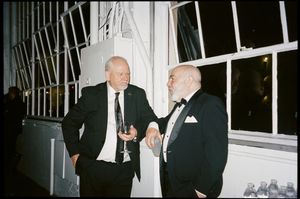 A series of black and white surveillance camera photos showing figures in suits and formal attire in an interior setting.