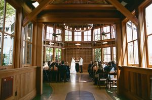 Elegant wood-paneled corridor with large windows and natural light illuminating the historic interior architectural details.