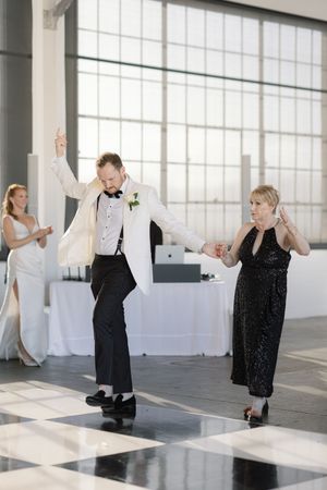 Playful dance moves on a shiny black and white checkered floor.