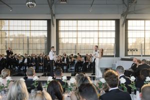 Modern industrial wedding venue with floor-to-ceiling windows and minimalist decor.