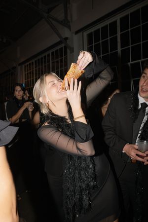 Guests enjoying drinks and celebration at a dimly lit party.