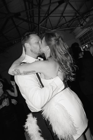 Dancing couple in formal attire sharing intimate moments at their wedding reception.