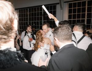 Guests mingling and dancing at a nighttime celebration.